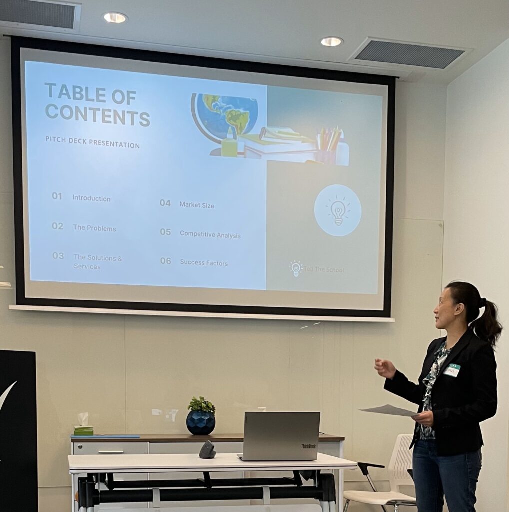 Joan, founder of Myrimaven, presenting a pitch deck to show strategic and culturally responsive support.