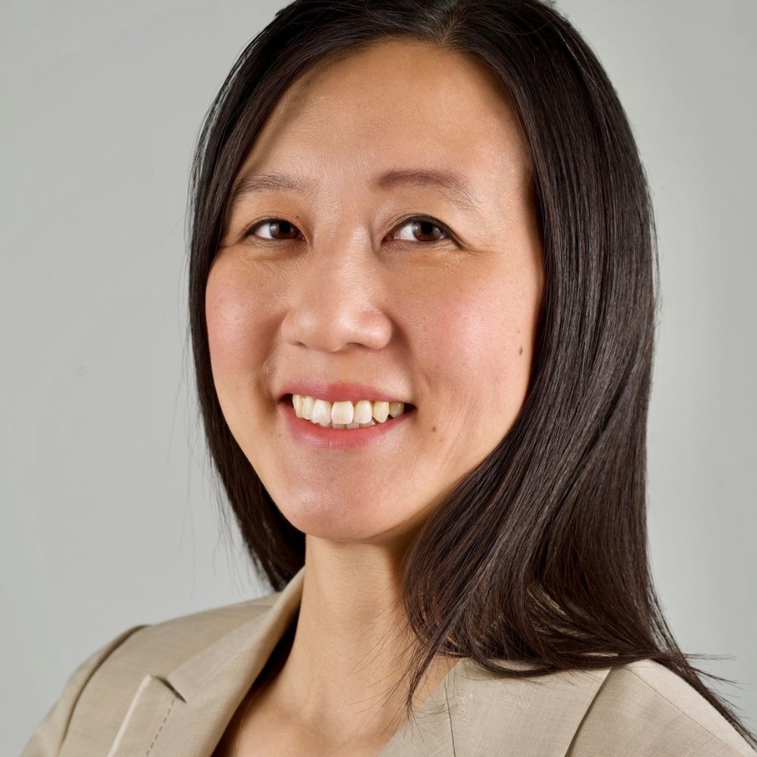 Joan, founder of Myrimaven, smiling in a professional headshot.